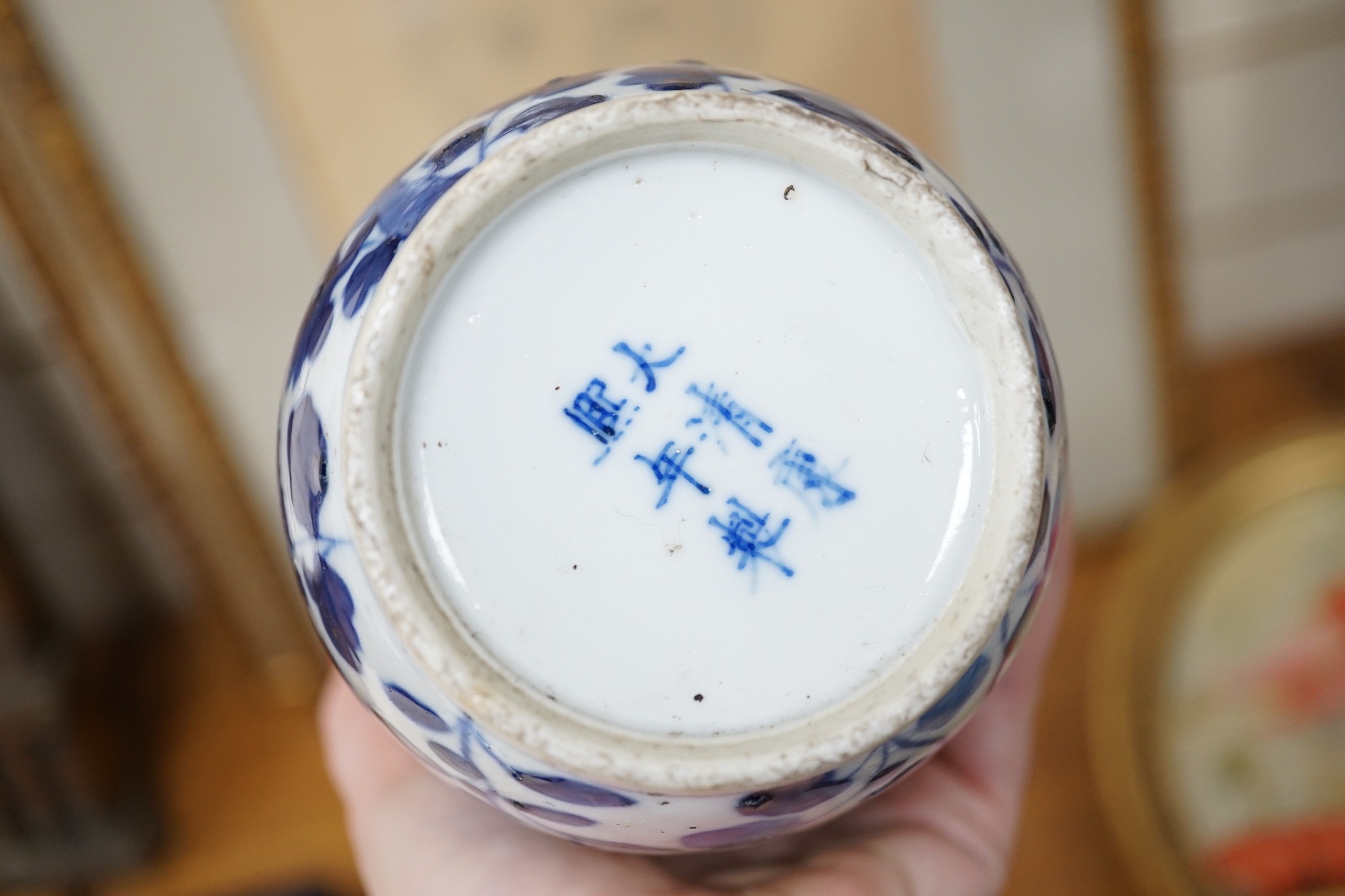 Two Japanese Satsuma boxes and covers, 10cm wide, and a blue and white Chinese vase, 26cms high